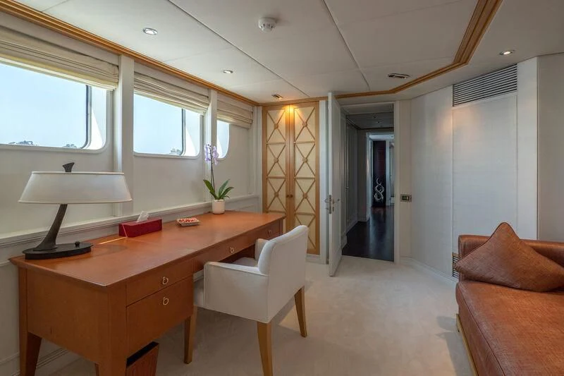 a room with a desk and a couch aboard DEEP BLUE II Yacht for Charter