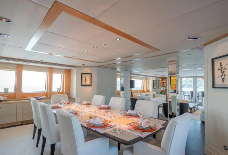 a dining room with tables and chairs aboard DEEP BLUE II Yacht for Charter