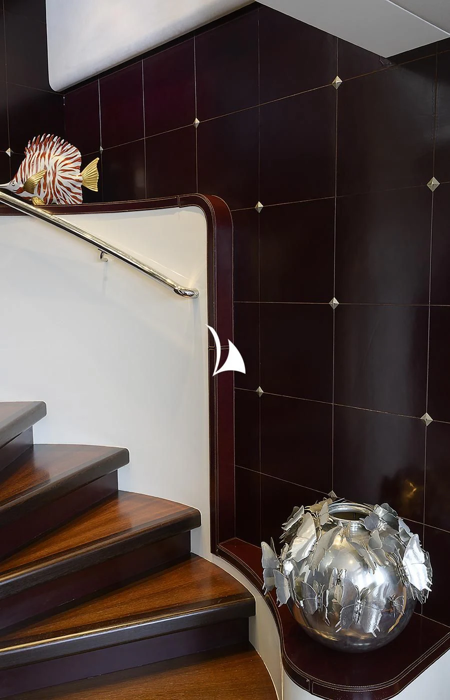 a room with a tile wall and a metal bucket on the wall aboard DEEP BLUE II Yacht for Charter