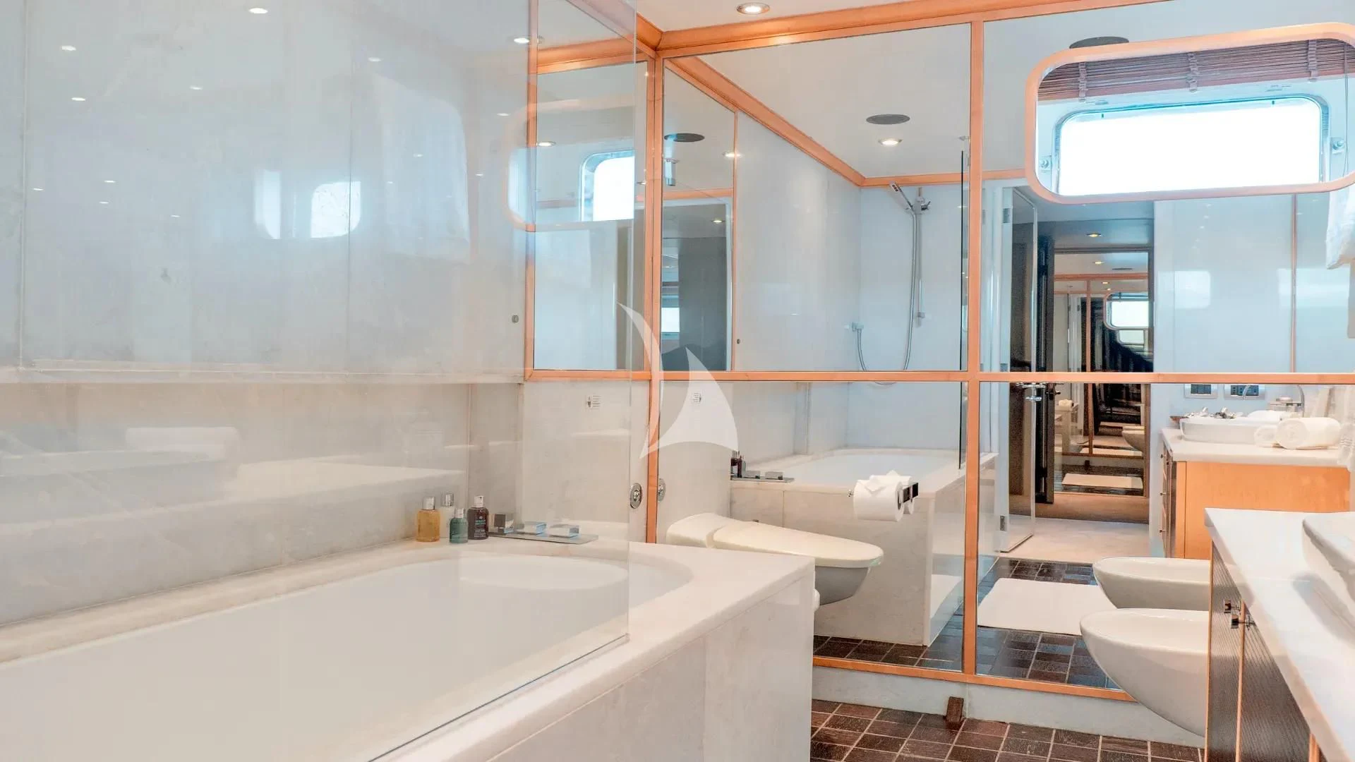 a bathroom with a tub sink and a toilet aboard DEEP BLUE II Yacht for Charter