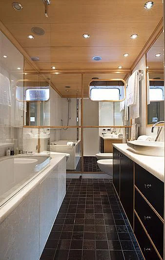 a bathroom with a tub sink and toilet aboard DEEP BLUE II Yacht for Charter