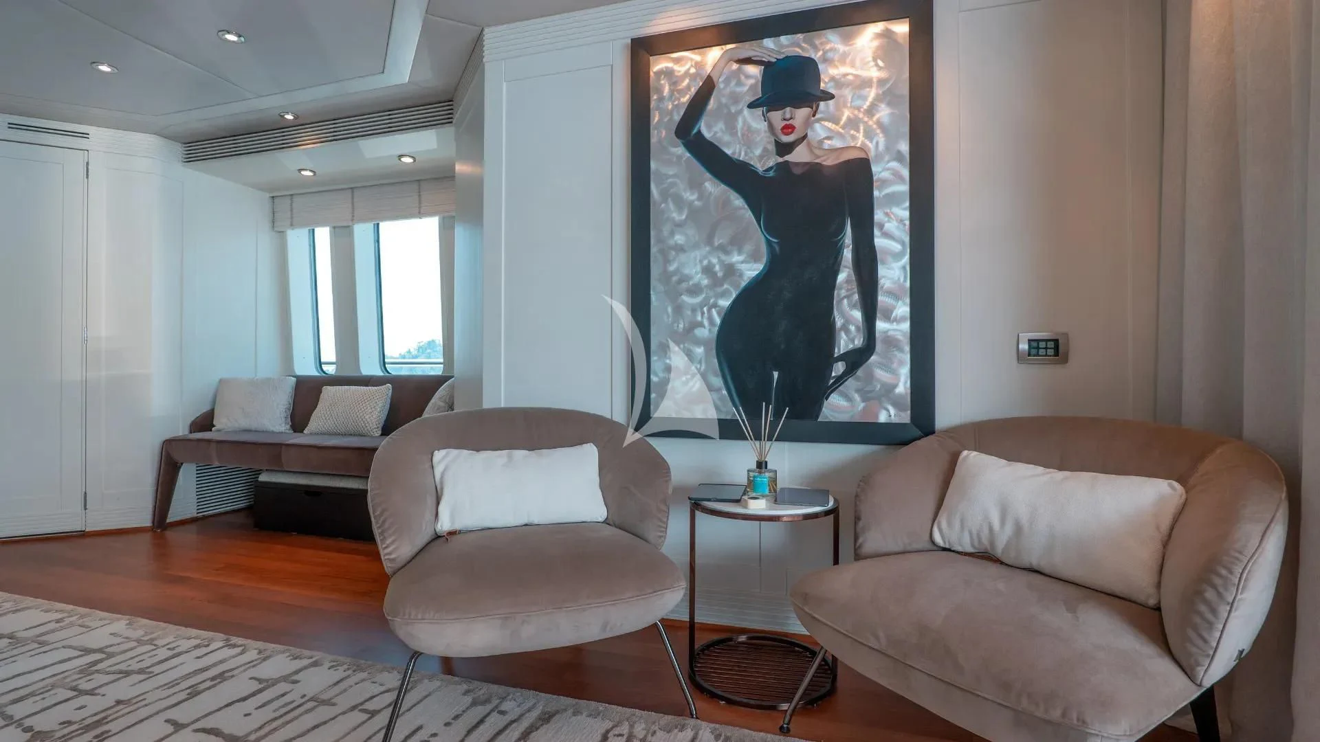 a living room with a painting on the wall aboard DEEP BLUE II Yacht for Charter