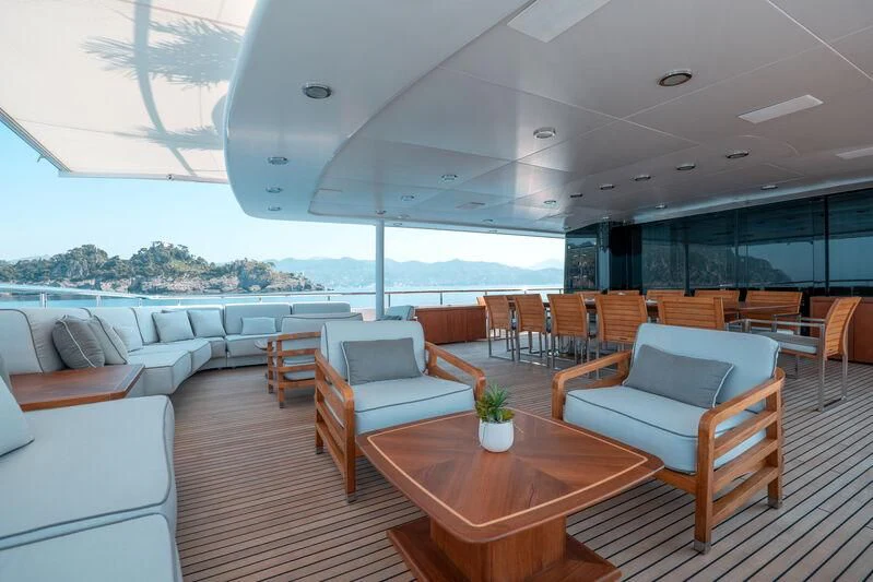 a room with a table chairs and a large window aboard DEEP BLUE II Yacht for Charter