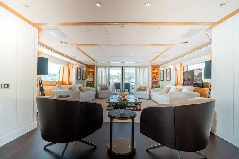 a living room with a black chair aboard DEEP BLUE II Yacht for Charter