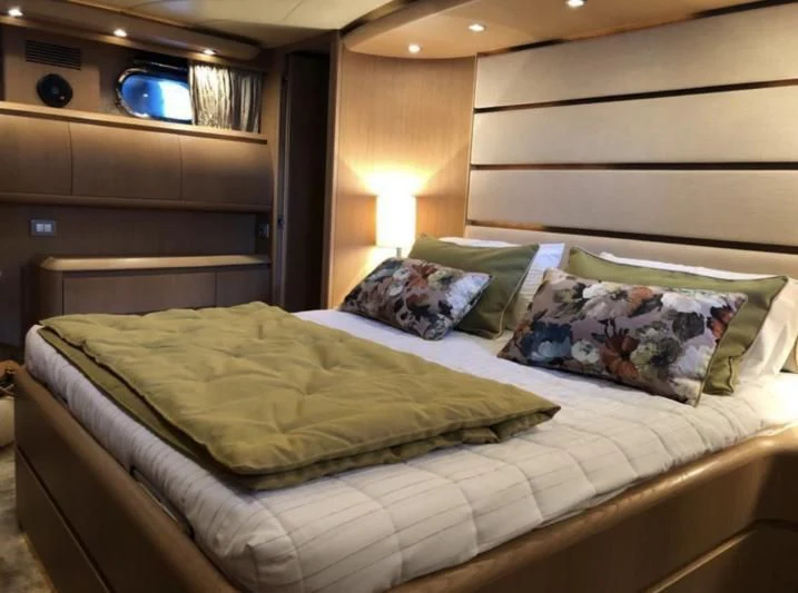 a bed with a white comforter aboard DUBAI Yacht for Sale