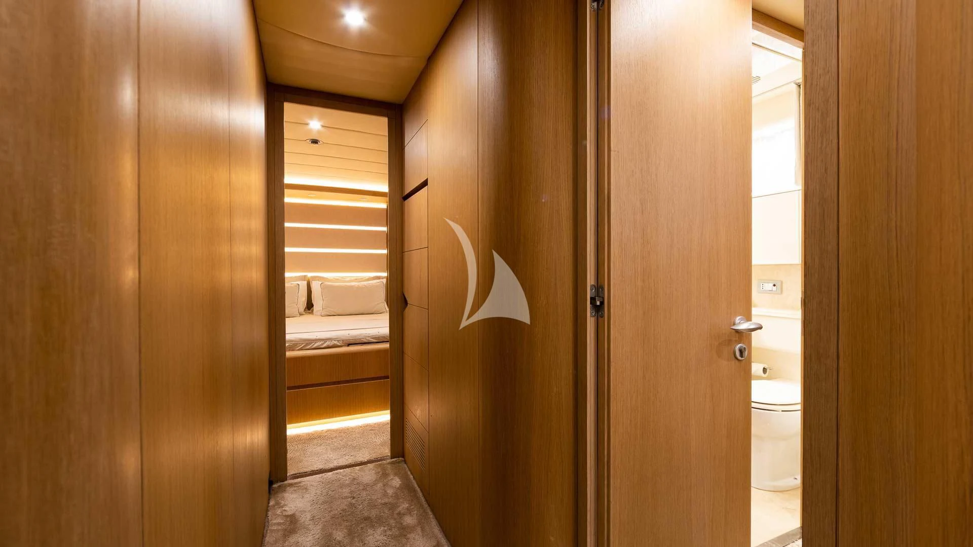 a bathroom with a wood door aboard DUBAI Yacht for Sale