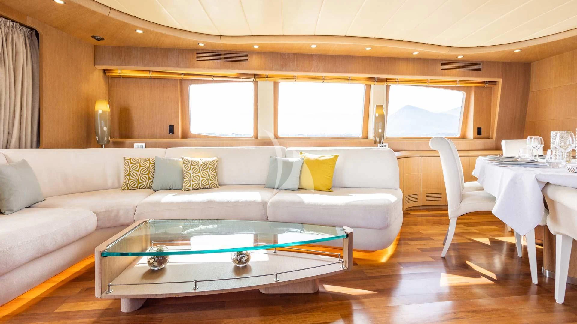 a living room with a table and couches aboard DUBAI Yacht for Sale