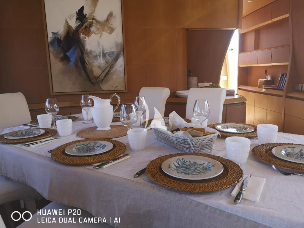 a table with plates and cups aboard DUBAI Yacht for Sale