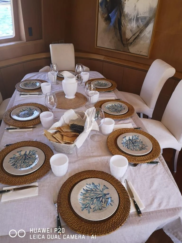 a table with plates and cups aboard DUBAI Yacht for Sale