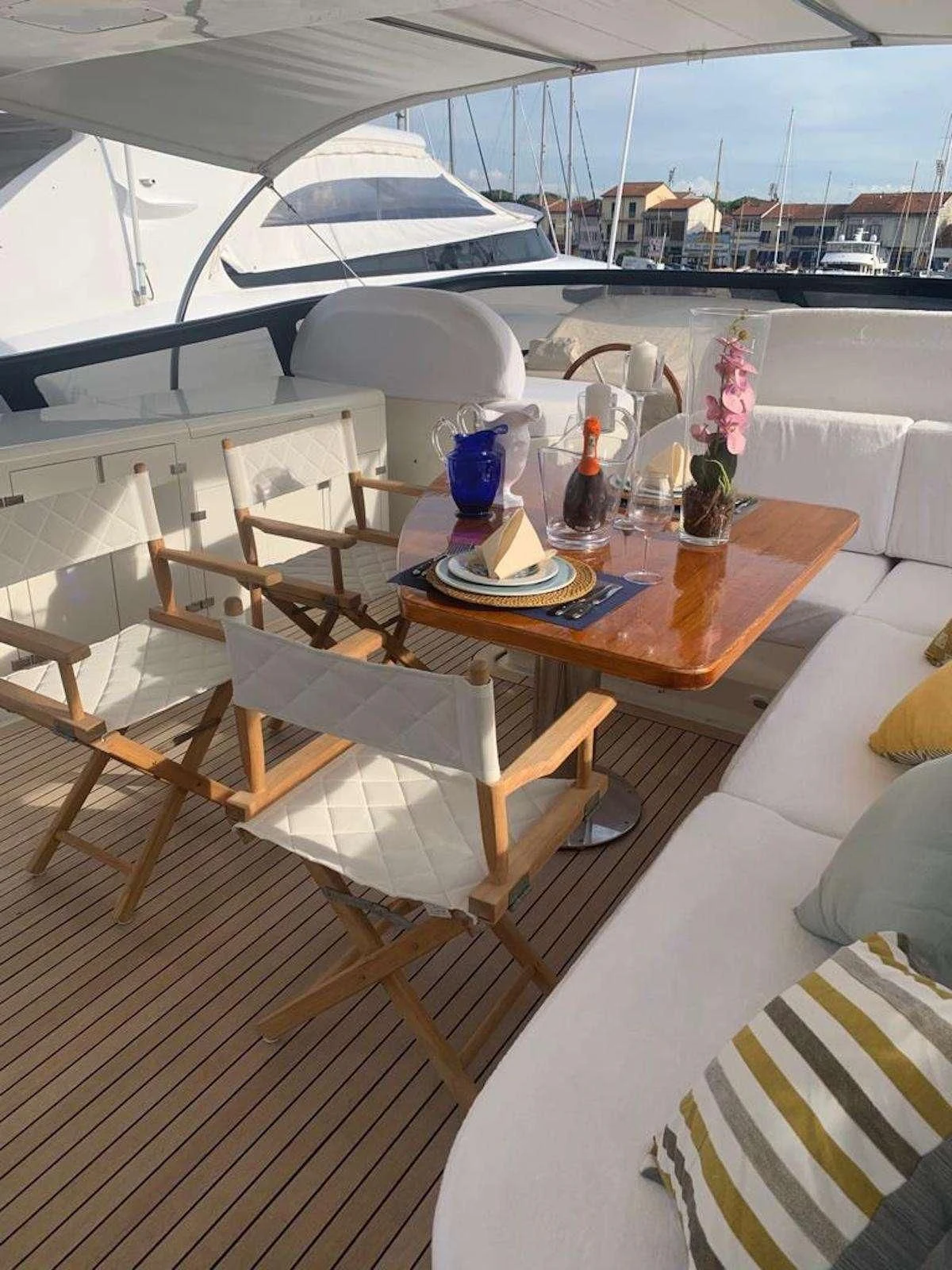 a table with chairs and a glass window overlooking a city aboard DUBAI Yacht for Sale