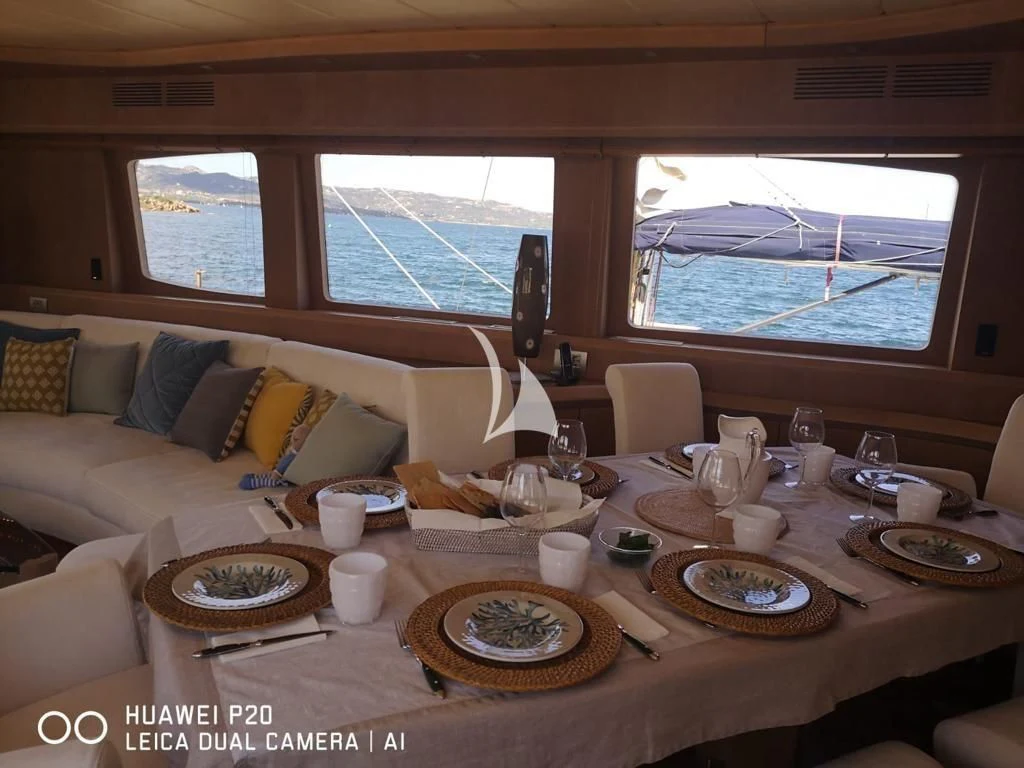 a table with plates and cups on it aboard DUBAI Yacht for Sale