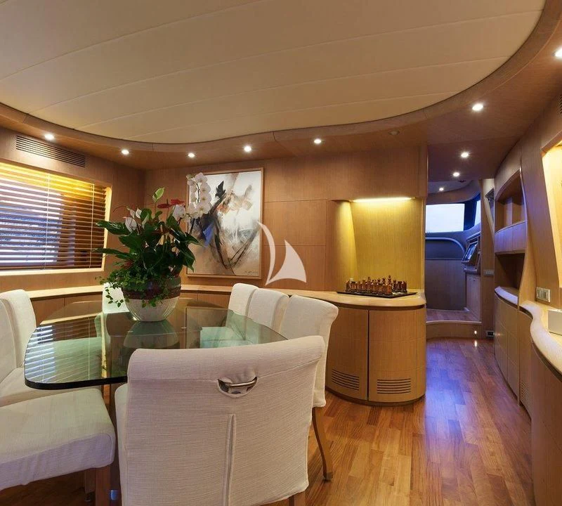 a living room with a table and chairs aboard DUBAI Yacht for Sale