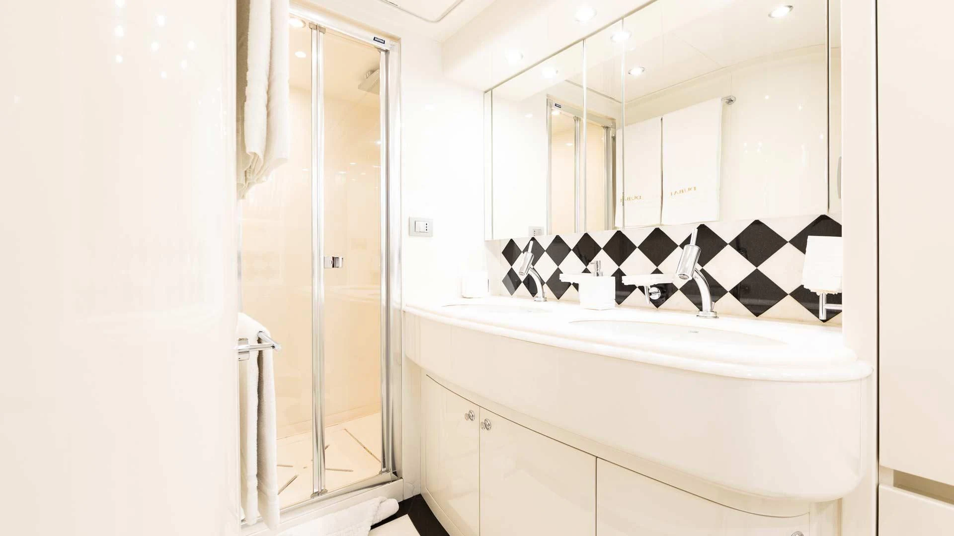 a bathroom with a large mirror aboard DUBAI Yacht for Sale
