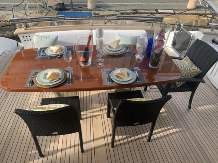 a table with plates and glasses on it aboard DUBAI Yacht for Sale
