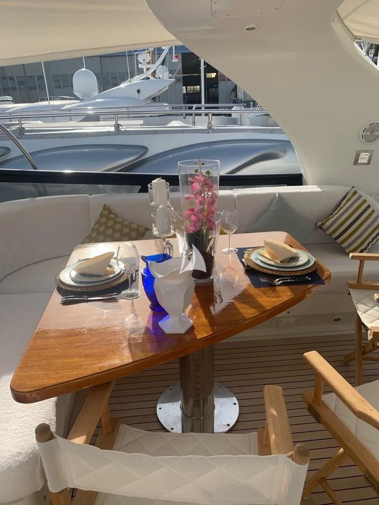 a table with plates and glasses on it aboard DUBAI Yacht for Sale
