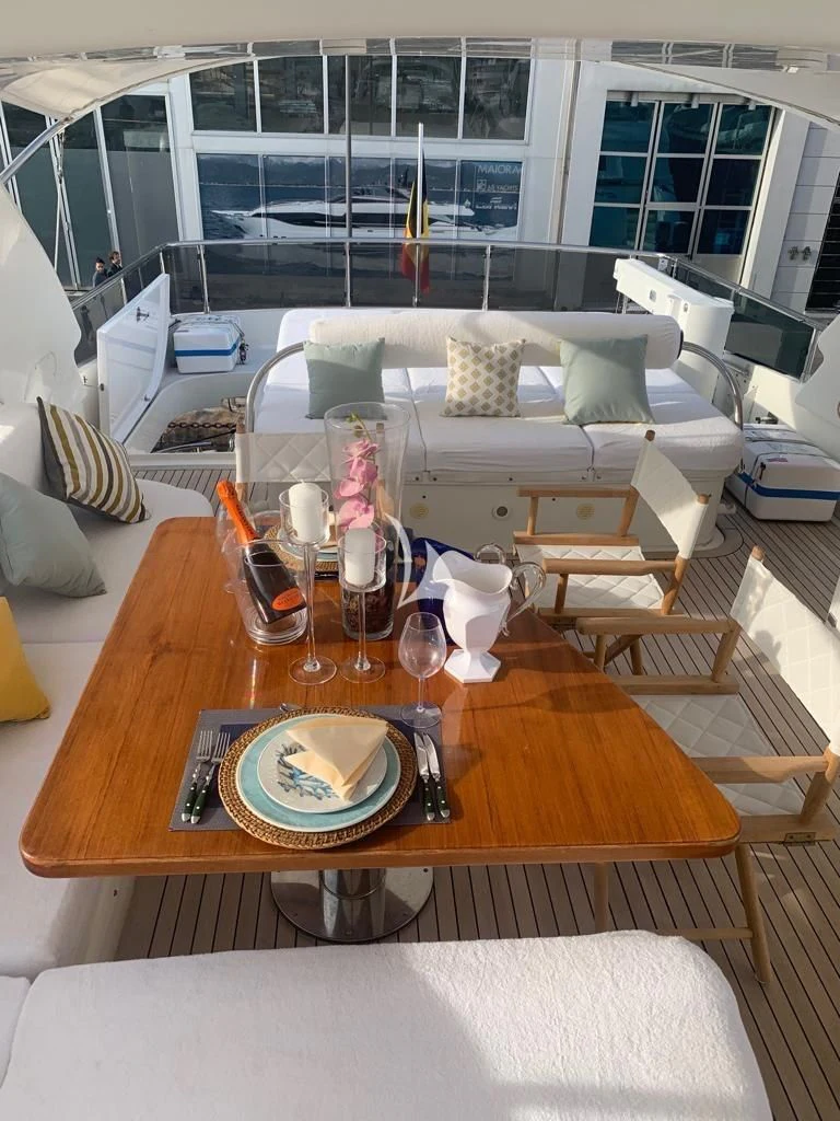 a table with glasses and a plate on it aboard DUBAI Yacht for Sale