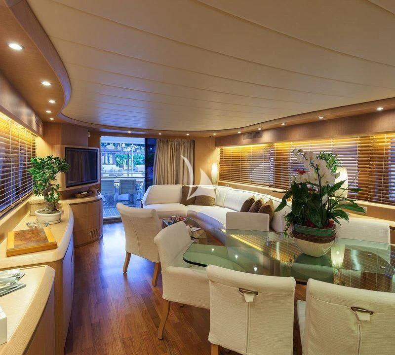 a living room with a table and chairs aboard DUBAI Yacht for Sale