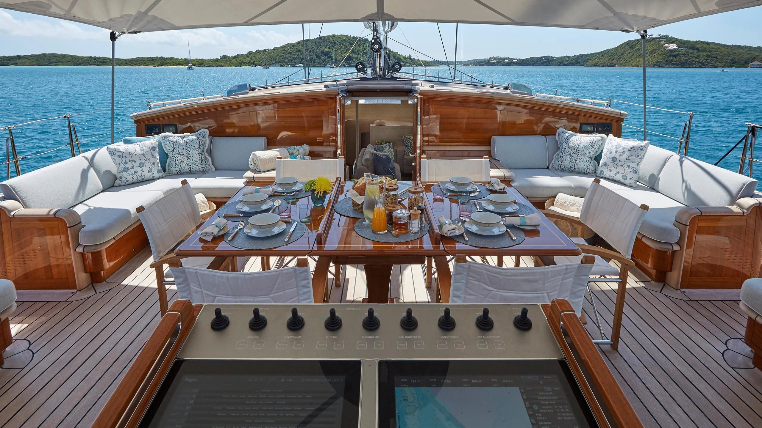 a table set for a meal on a deck overlooking the ocean aboard ELFJE Yacht for Sale