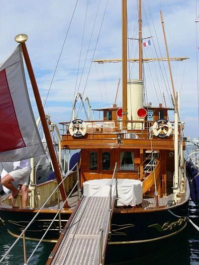 a boat with a red and white sail aboard ATLANTIDE Yacht for Sale