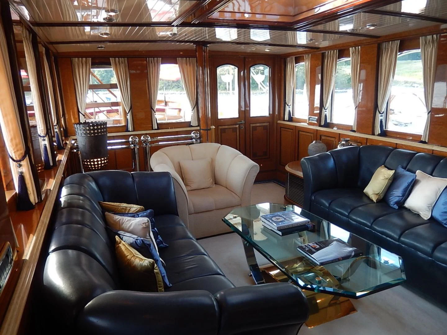 a living room with leather couches aboard ATLANTIDE Yacht for Sale