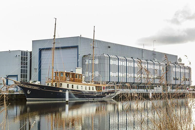 a boat docked in front of a building aboard ATLANTIDE Yacht for Sale