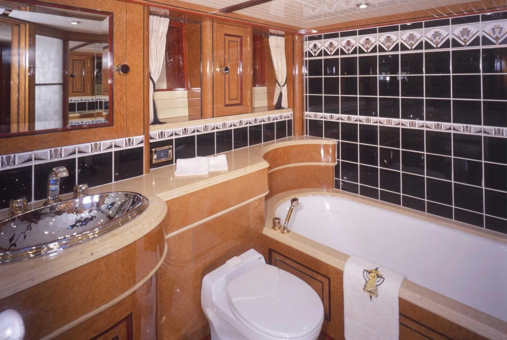 a bathroom with a tub sink and toilet aboard ATLANTIDE Yacht for Sale