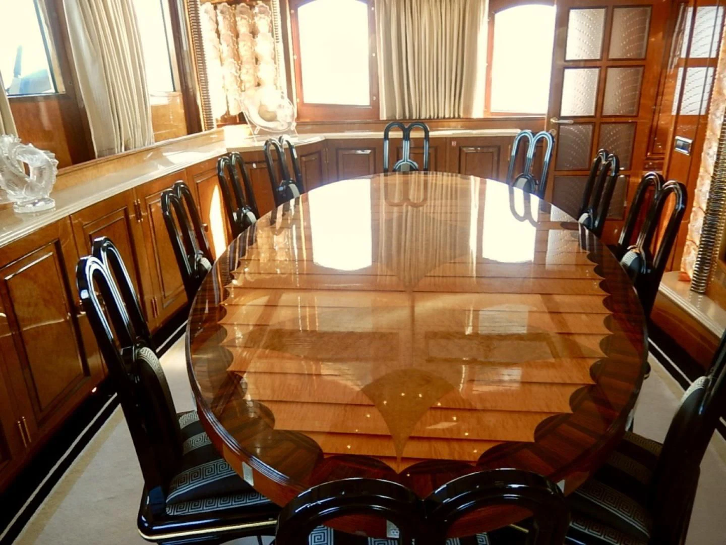 a dining table with chairs aboard ATLANTIDE Yacht for Sale
