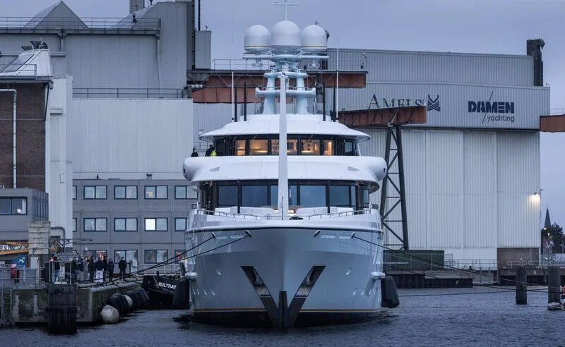 a large white boat in front of a building aboard AVANTI Yacht for Sale