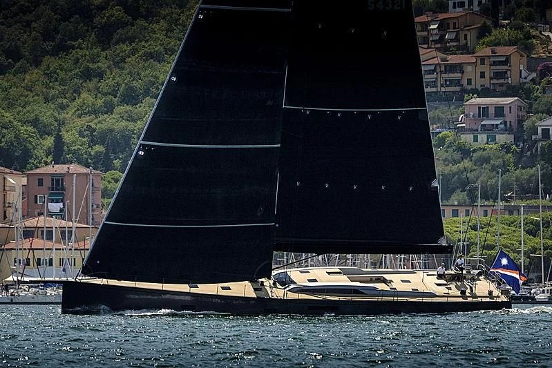 a large black sailboat on the water aboard SORCERESS Yacht for Sale