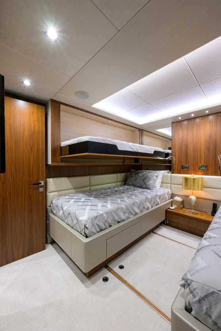 a room with a bed and a desk aboard SKYCHASER Yacht for Sale