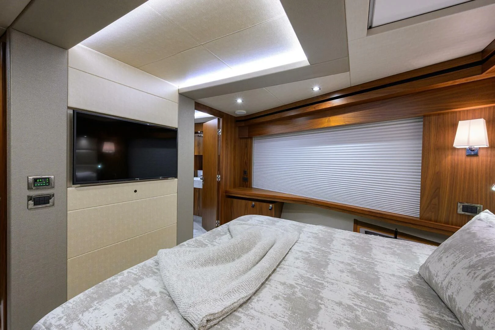 a bed with a television on the wall aboard SKYCHASER Yacht for Sale