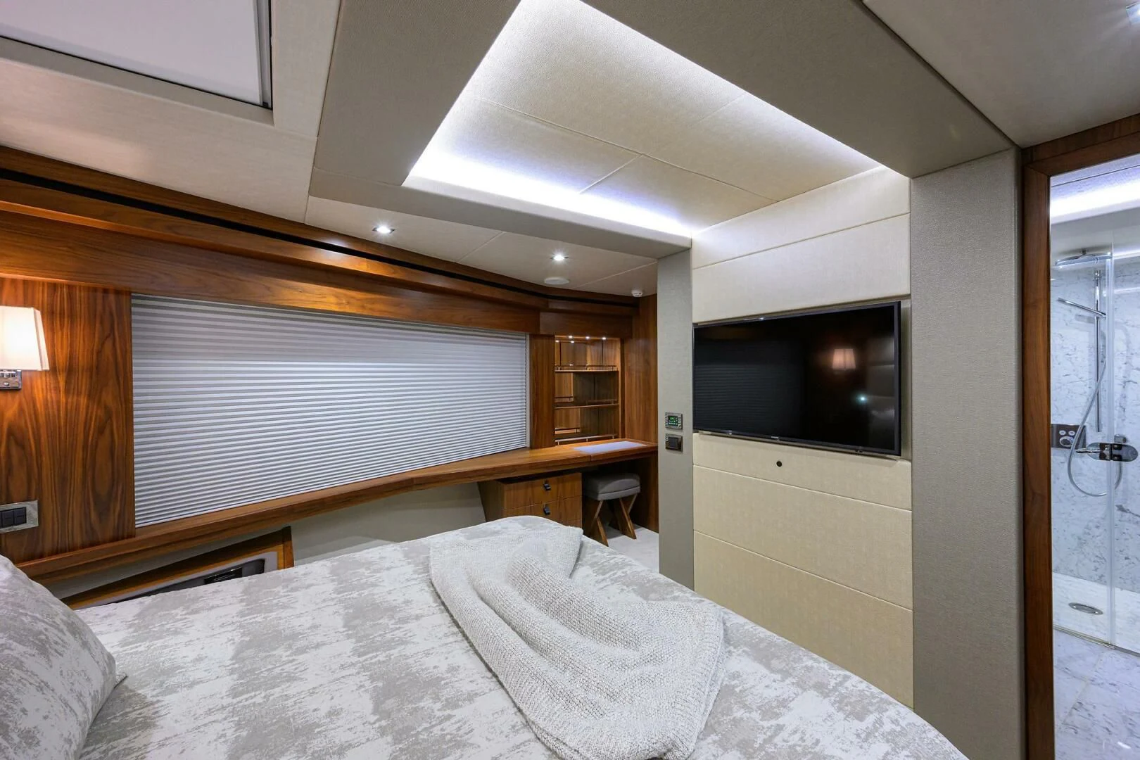 a bed with a television on the wall aboard SKYCHASER Yacht for Sale