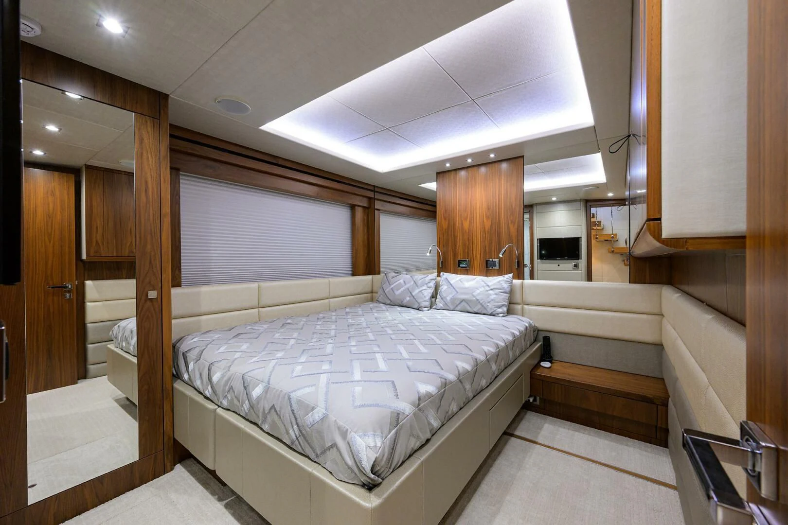 a room with a bed and a wood door aboard SKYCHASER Yacht for Sale
