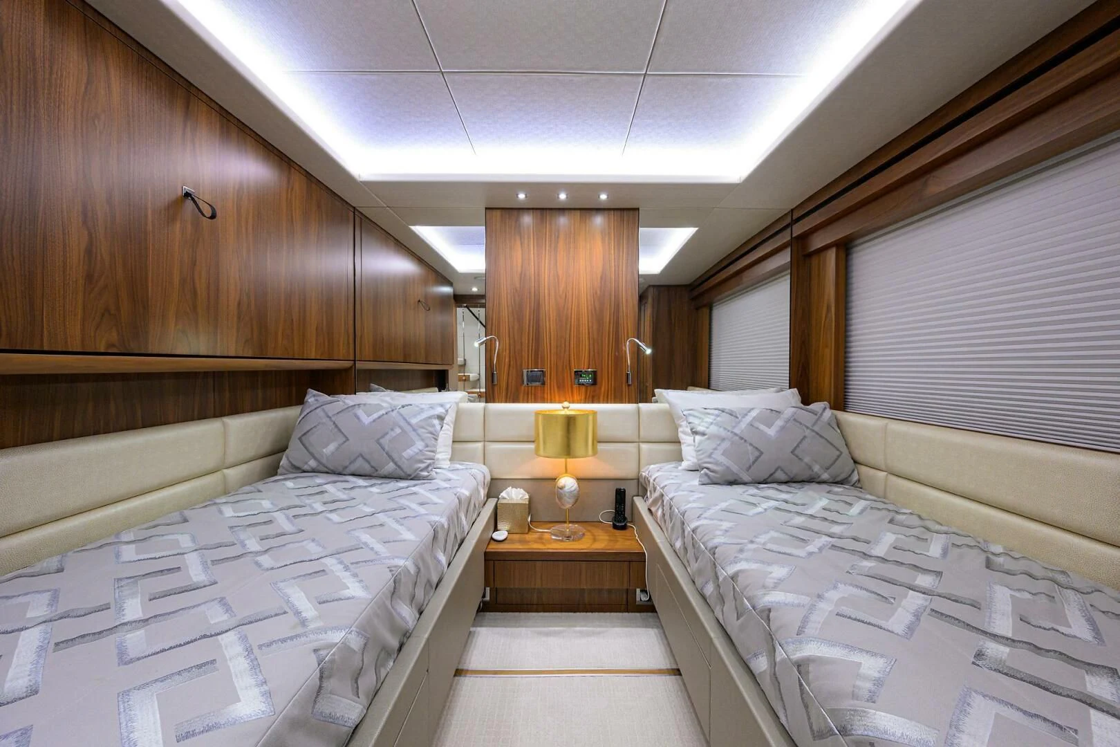 a room with beds and a lamp aboard SKYCHASER Yacht for Sale
