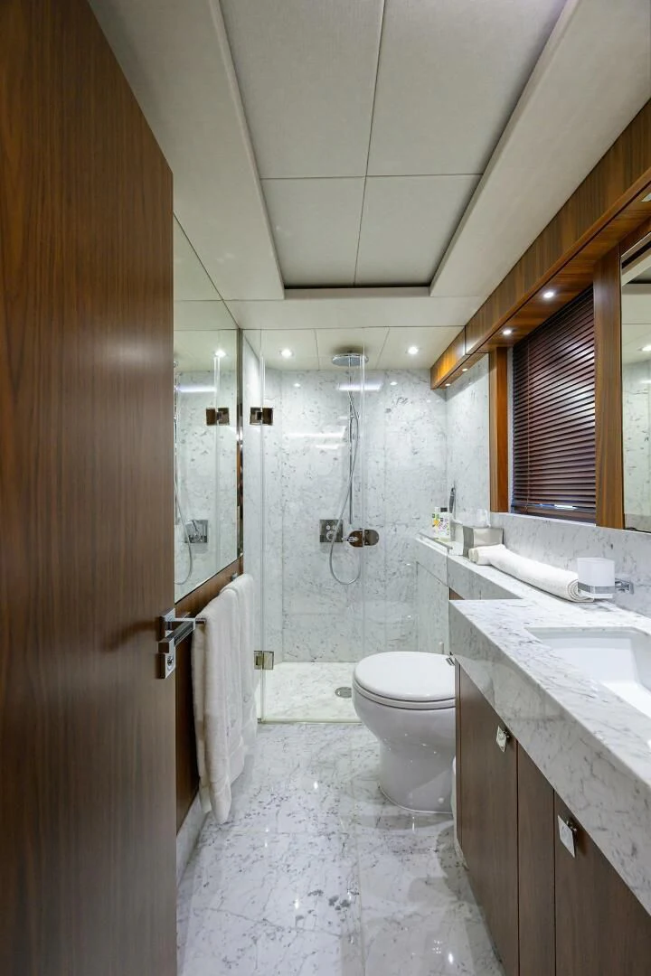 a bathroom with a toilet and sink aboard SKYCHASER Yacht for Sale
