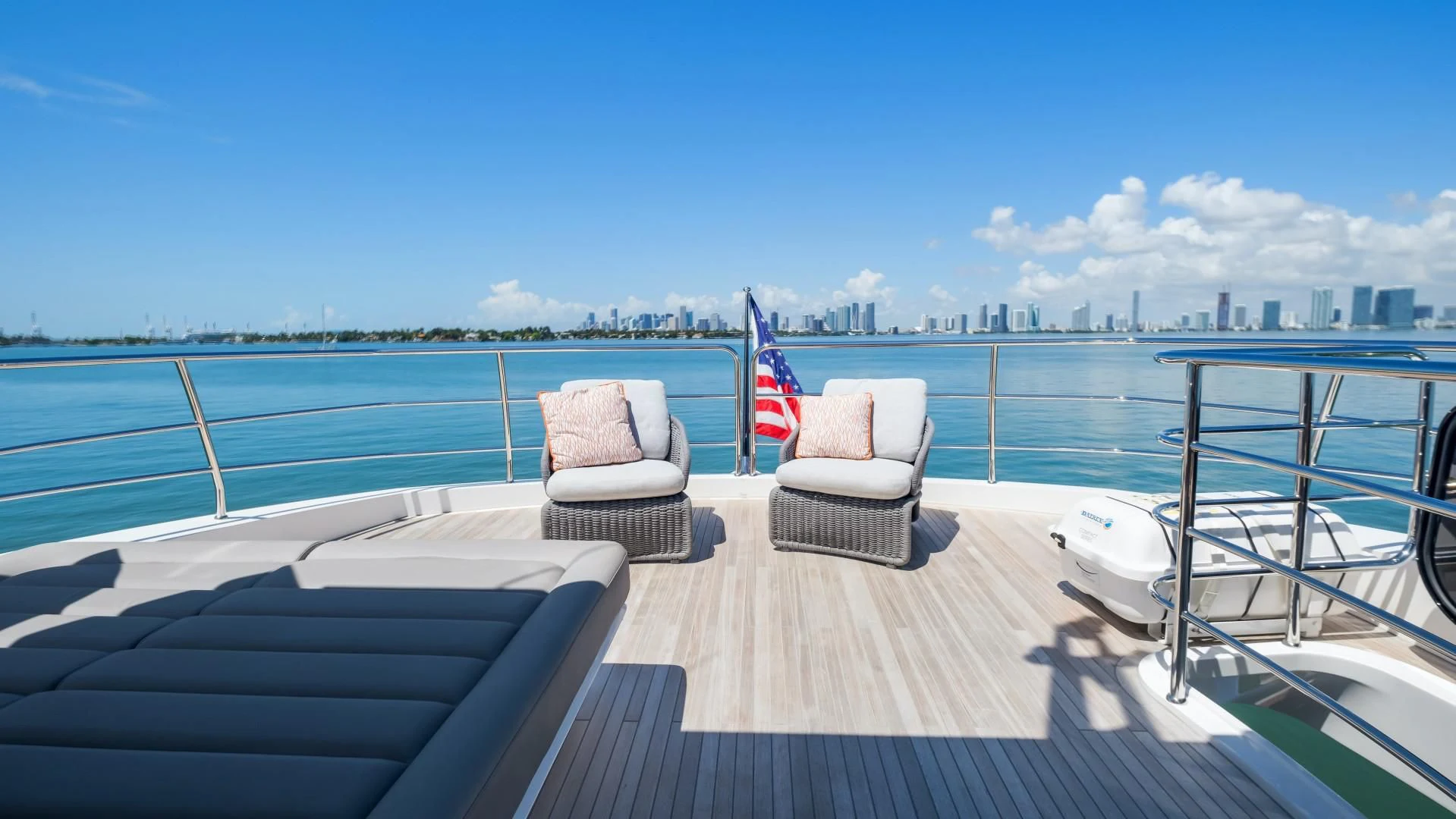 a deck with chairs and a flag on it aboard SKYCHASER Yacht for Sale