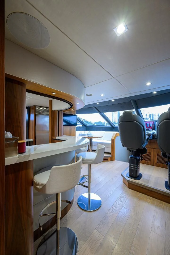 a room with tables and chairs aboard SKYCHASER Yacht for Sale