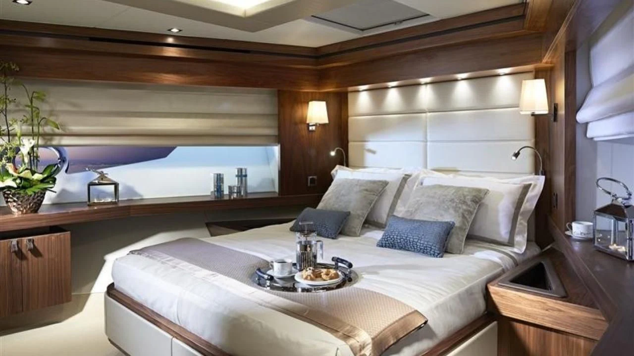 a bed with a tray of food aboard SKYCHASER Yacht for Sale