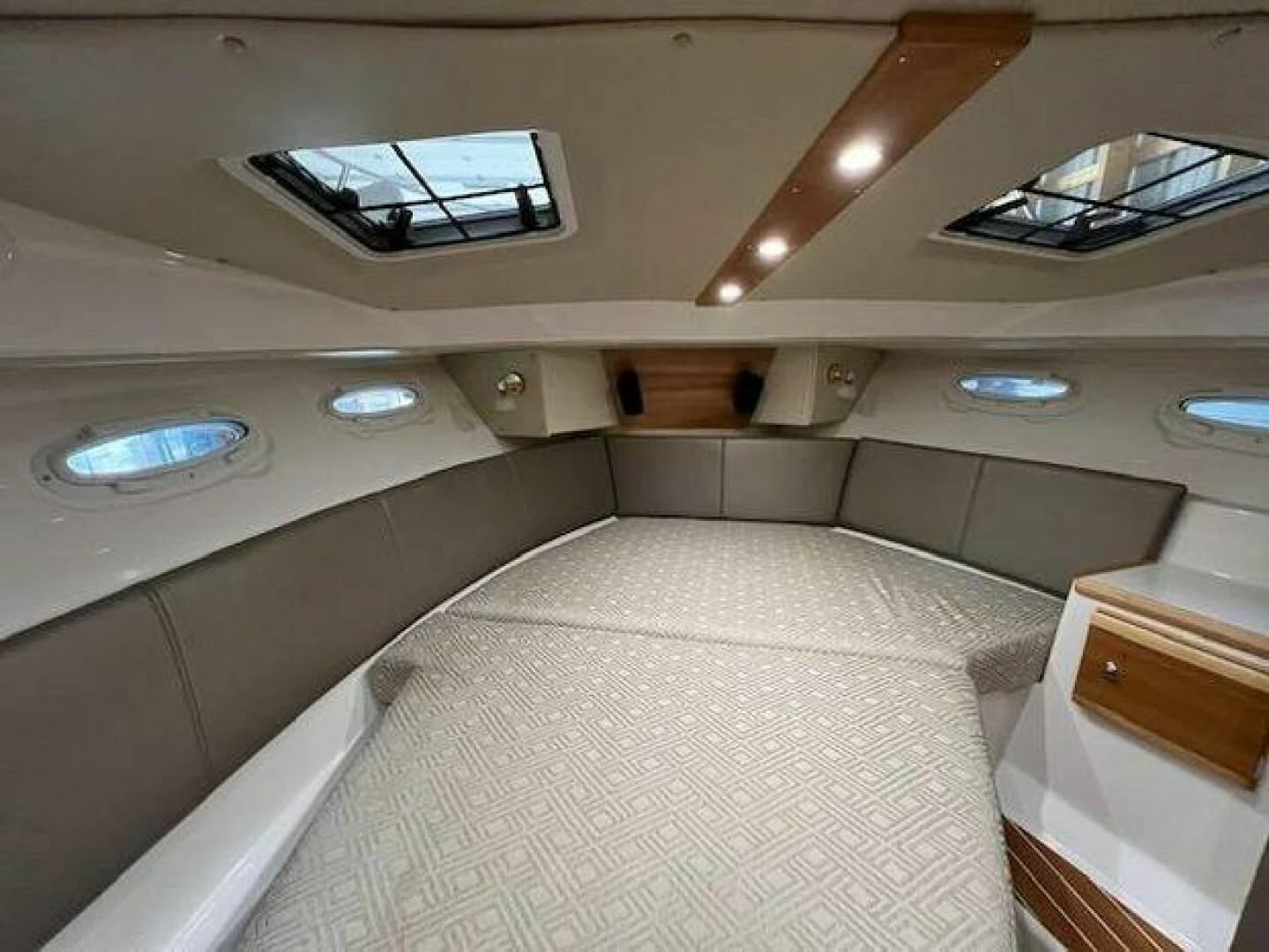 a room with a bed and a sink aboard SKYCHASER Yacht for Sale
