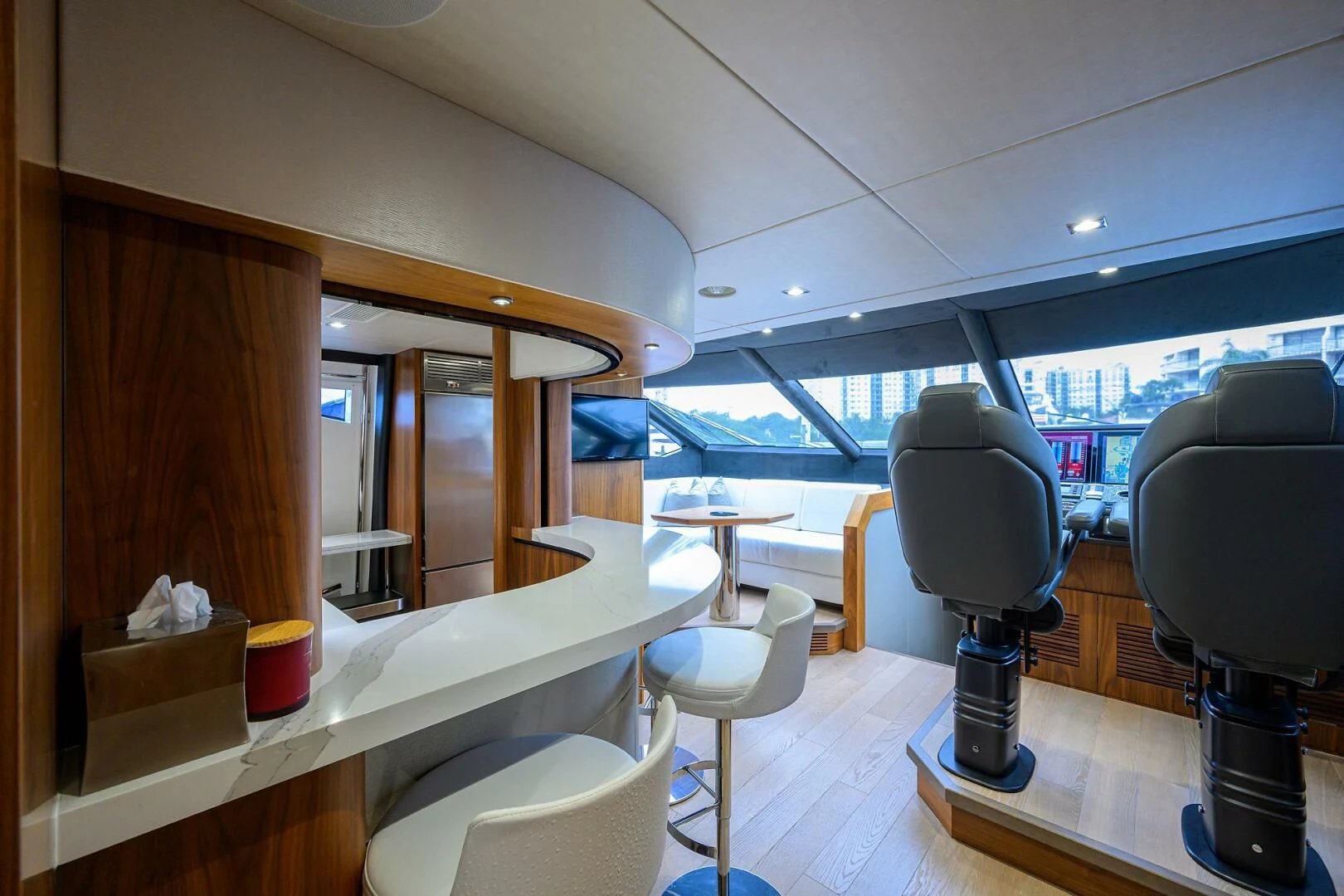 a room with a large mirror and a desk with chairs aboard SKYCHASER Yacht for Sale