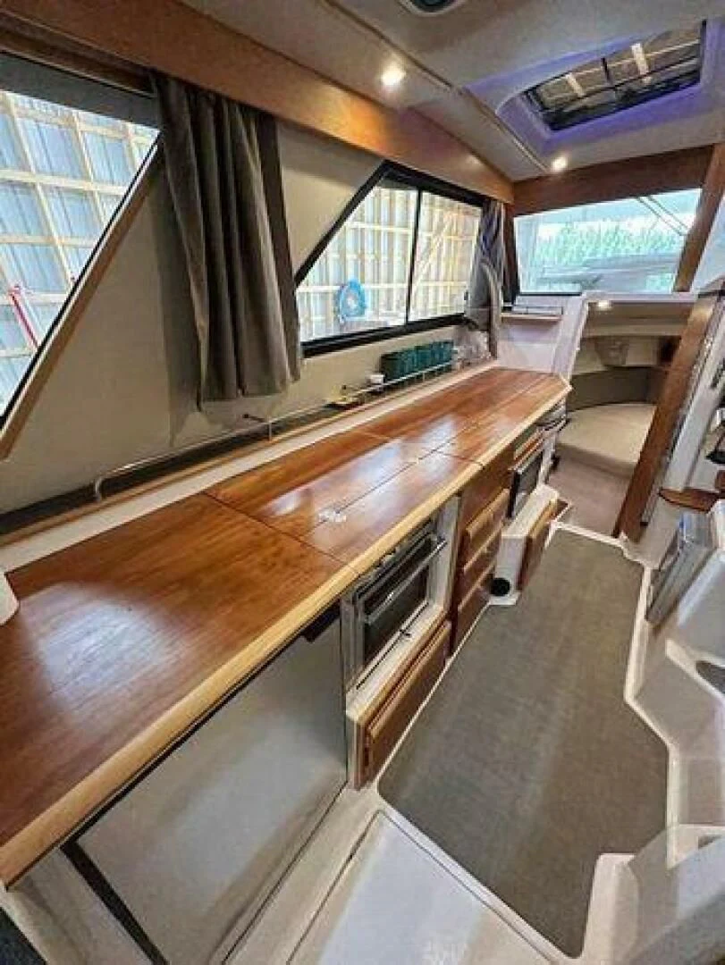 a room with a table and chairs aboard SKYCHASER Yacht for Sale