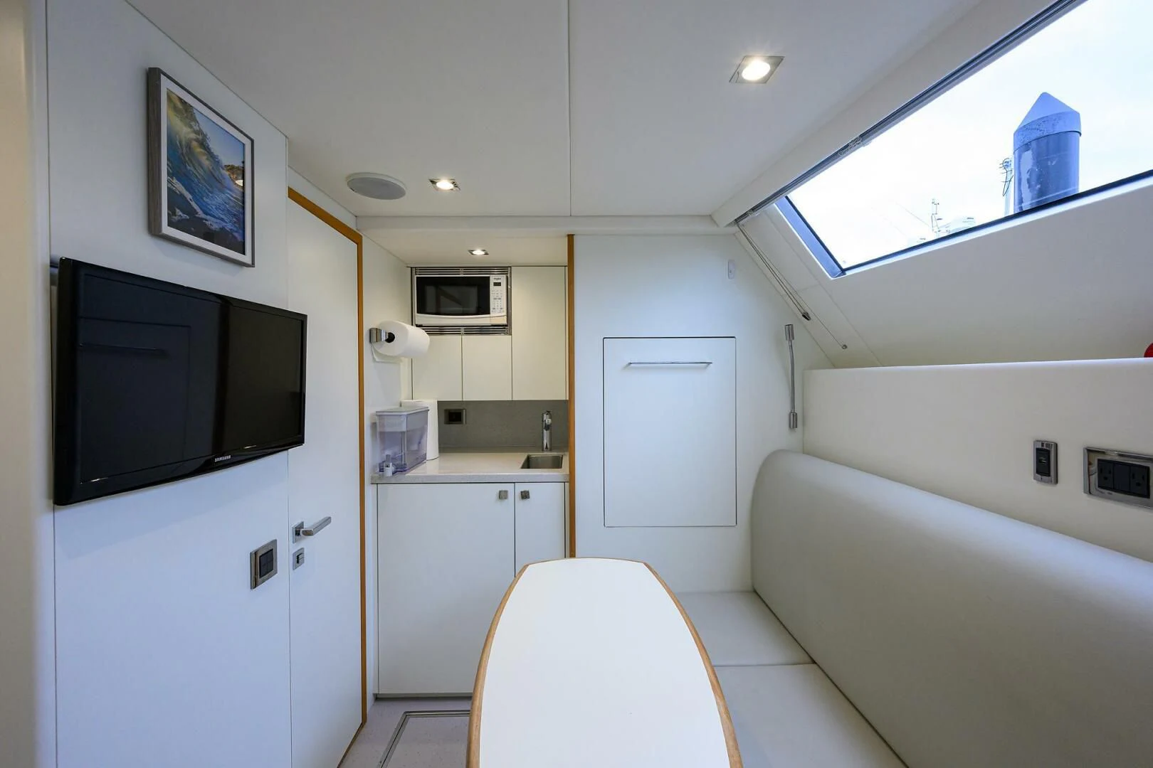 a bathroom with a tv and a bathtub aboard SKYCHASER Yacht for Sale