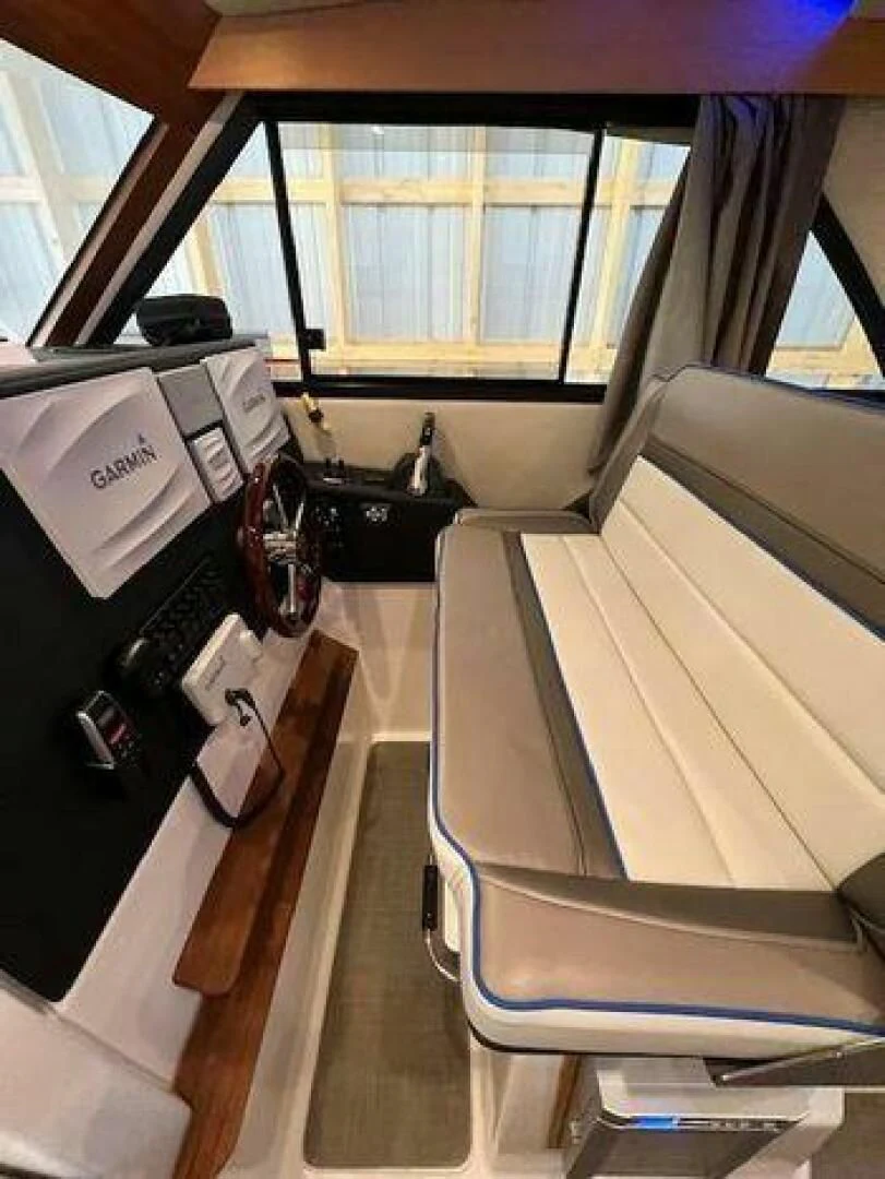 a boat with a seat and a desk with a camera on it aboard SKYCHASER Yacht for Sale
