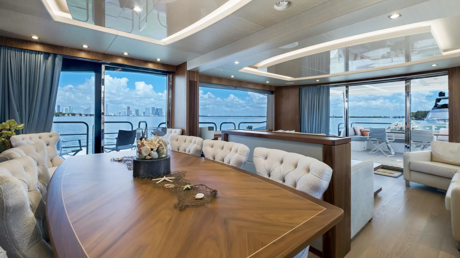 a living room with a large table aboard SKYCHASER Yacht for Sale