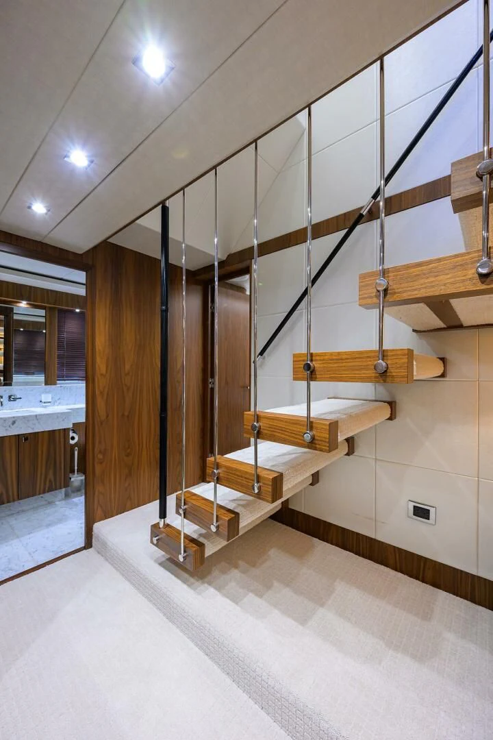 a room with wooden stairs aboard SKYCHASER Yacht for Sale