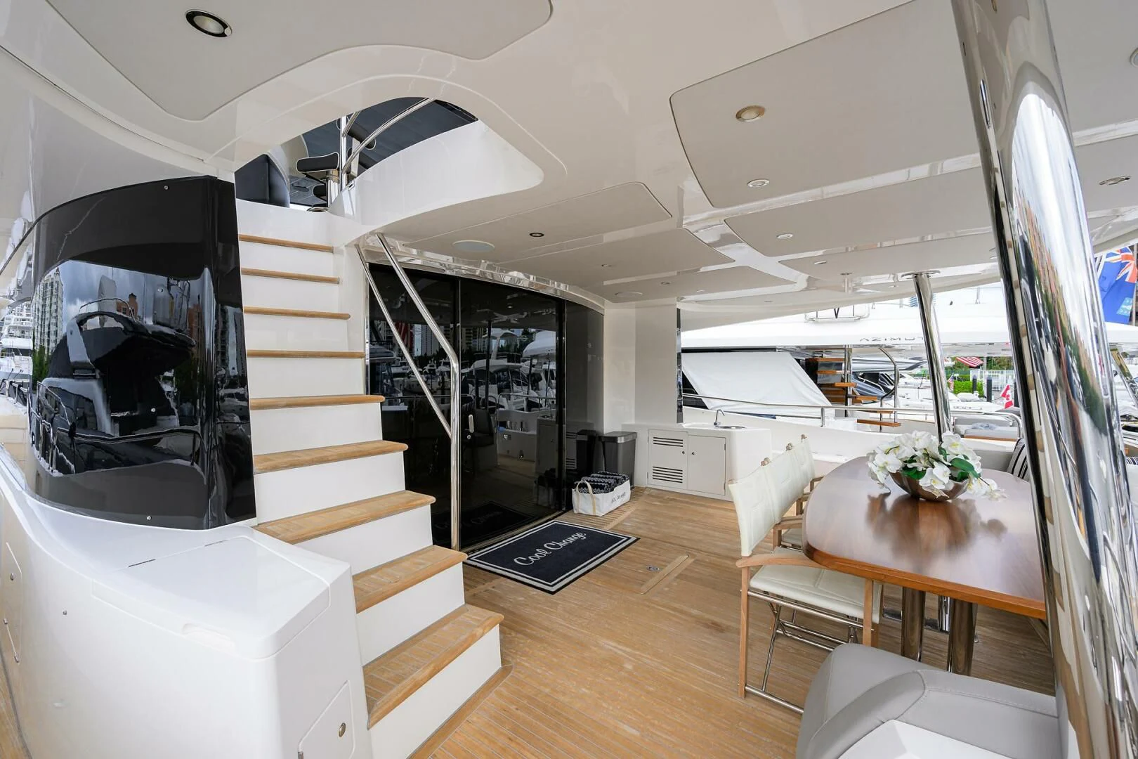 a room with a staircase and a table and a tv aboard SKYCHASER Yacht for Sale