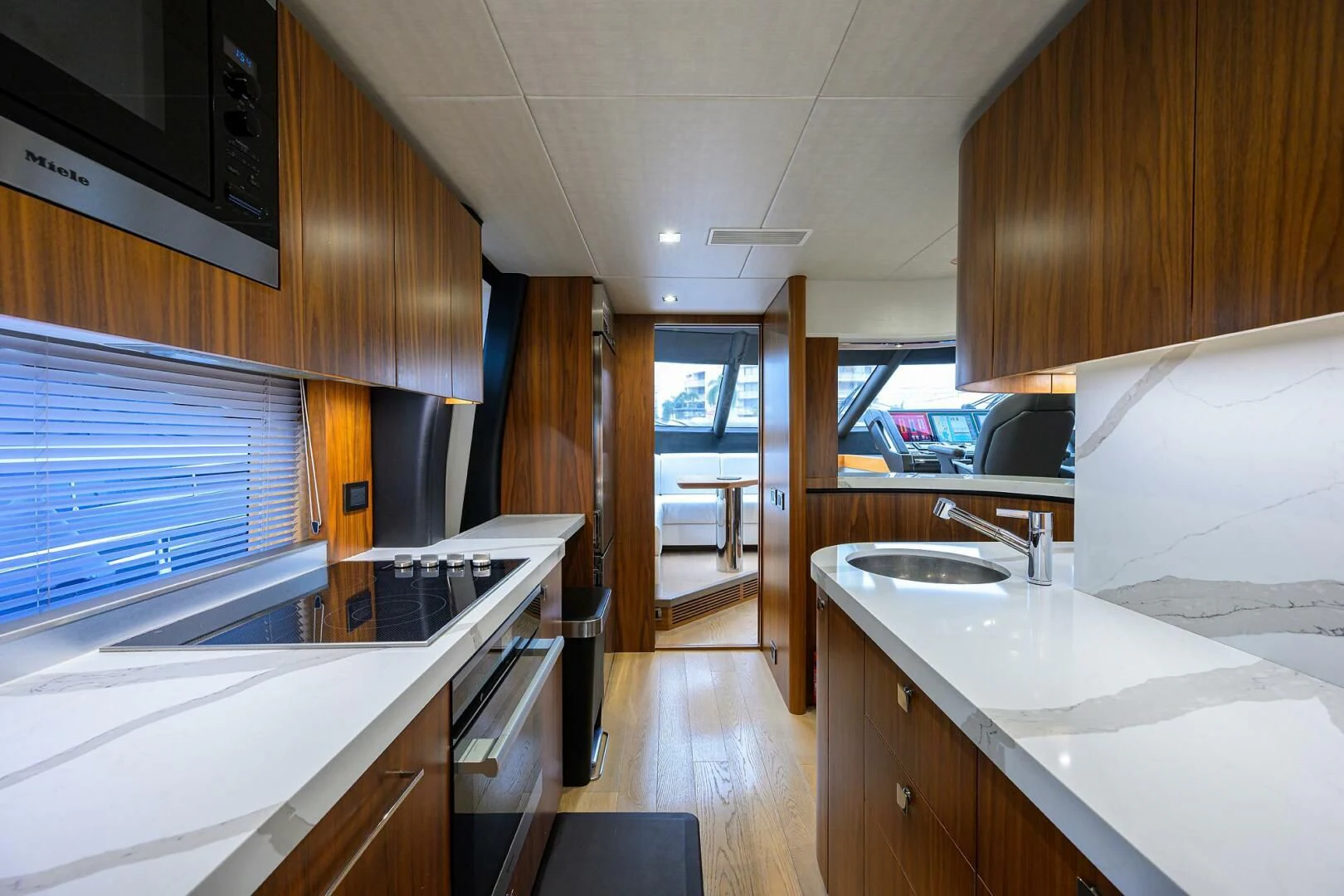 a kitchen with a microwave oven and a sink aboard SKYCHASER Yacht for Sale