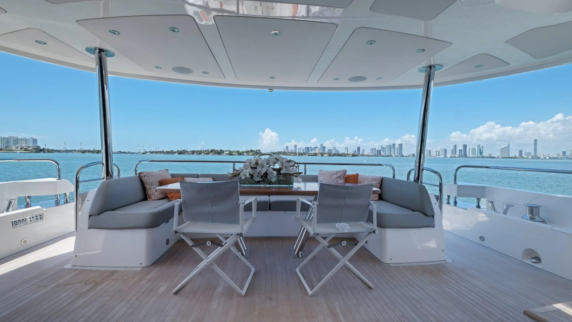 a room with a table and chairs on a deck aboard SKYCHASER Yacht for Sale
