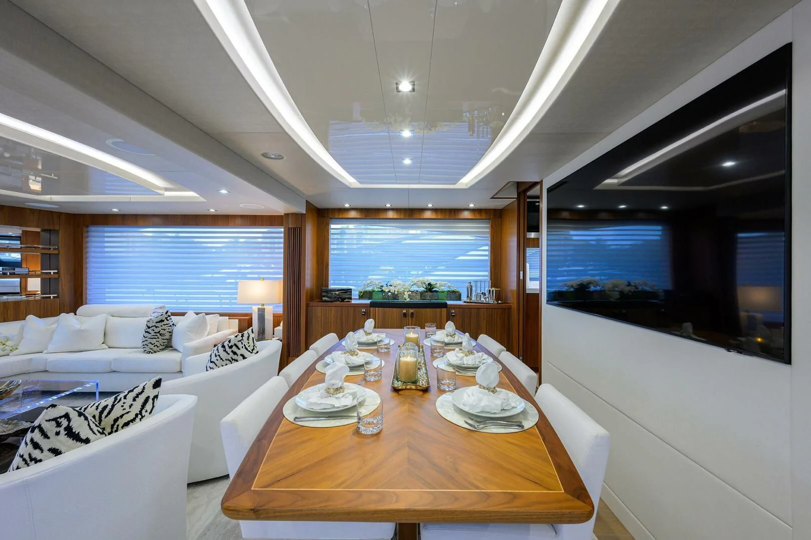 a large living room with a large table and a large window aboard SKYCHASER Yacht for Sale