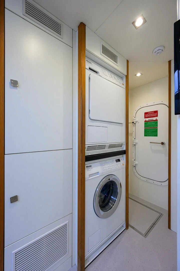 a closet with washer and dryer aboard SKYCHASER Yacht for Sale